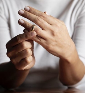 A women taking off a wedding ring